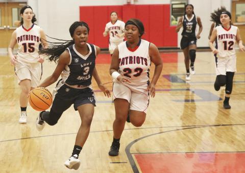 Lady Blue Devil freshman (left) drives to the basket during Elbert County’s 49-15 win at Oglethorpe High School Jan. 17 in Lexington. (Photo by Dan Giles)