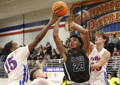 Blue Devil freshman Christian Harris (center) shoot between Patriot defenders during Elbert County’s 76-37 region win at Oglethorpe County Jan. 17 in Lexington.(Photo by Dan Giles) 