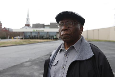 Randolph Davis (top) looks toward Elbert Street as he stands in front of Regions Bank. Davis’ father’s barbershop and other African-American businesses sat on the property where the bank is now before the street was widened in the 1960s. (Photo by Scoggins)
