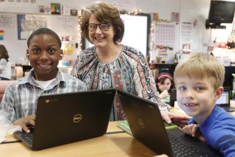Elbert County Elementary School Principal Stephanie Wiles checks out the work of students Ethan Watkins (left) and Levi Wiles (right) on computers at the school recently. (Photo by Scoggins)