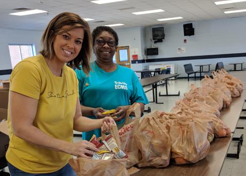 Tina Hudson, School Nutrition Coordinator, and Doris Allen, School Nutrition Assistant, pack bags for the Elbert County School System’s ‘Grab and Go’ lunch program.