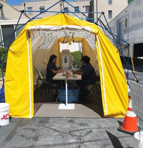 Andrea Webb (left) and Margie Rucker are screening all persons entering Elbert Memorial Hospital in a tent outside of the hospital’s emergency room. (Photo by Jones) 