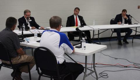 Elberton Star Publisher Gary Jones (L) and WSGC Radio’s Linton Johnson (R) in the foreground asked Georgia House Rep. District 33 candidates questions at last week’s forum at the county government complex – the candidates are (L-R) Bruce Azevedo of Madison County, Rob Leverett of Elbert County and Tripp  Strickland of Madison County. (Photo by Scoggins)
