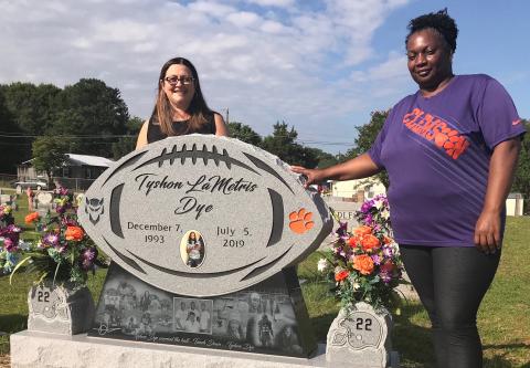 Angie Bonds (left) and Peggy Dye recently visited Lincoln Heights Cemetery to talk about the unique monument created to honor the memory of Peggy’s son, Tyshon Dye. (Photo by Jones)