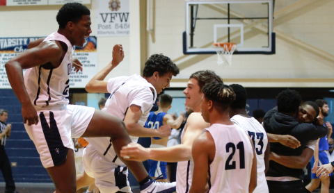 Sophomores Quon Moss (far left) and Kane Hughes and juniors Bryce Dickerson and Trustin Allen (21) jump for joy after the Devils’ 89-85 victory over Banks in double OT Jan. 22 in the Inferno while juniors Jamil Burton and A.J. Henderson celebrate with a hug. (Photo by Scoggins) 