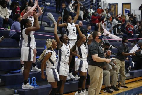 Sophomores (L-R) Lilly Ray, Terrace Hester, Niya Moon, junior Jordan Glaze, sophomores Brenasia Faust and Aaniyah Allen and Head Coach Josh Jones react to a score from senior Jedihah Williams in the Lady Devils’ competition against Union County during the Region 8-AA Tournament at Banks County Friday, Feb. 12. (Photo by Scoggins) 