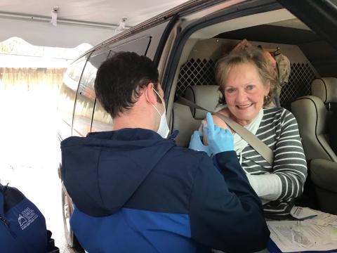Kathy Pfaender of Hartwell gets a vaccine from Athens Tech nursing student Alex Higgins at EMH’s drive-through Monday morning. (Photo by Jones)