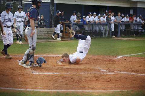 Sophomore Skylar Bray eats dirt with his helmet flying off as he slides into home in the bottom of the first during the Diamond Devils’ competition against Habersham Central Tuesday, March 23. (Photo by Scoggins)