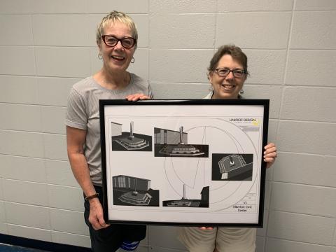 Gerry Besharat (left) and Pam Allgood display plans for the “Granite Feather,” which will displayed at the Elbert County Chamber of Commerce entrance. (Photo by Scoggins)