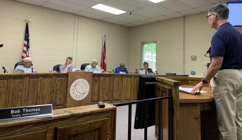 Elbert County Chief Financial Officer Phil Pitts (right) talks about the 2021-2022 budget in front of the Elbert County Board of Commissioners Monday afternoon. The commission approved the budget, which includes a $1.2 million increase, with over half for raises within the county government. (Photo by Scoggins)