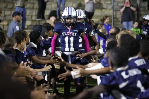 Blue Devil Christian Harris walks through a tunnel of future Blue Devils and current football players from Elbert County Parks and Recreation before the Oct. 15 game against Union County in the Granite Bowl. (Photo by Scoggins)