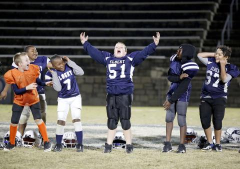 10U Elbert County Blue Devils (L-R) Chance Duck, Landon Newsome, JaMain Crosby, Justin Cleveland and Hayden Huff react to No. 51 Cole Freeman’s roar while being recognized during the community pep rally for the Elbert County Parks and Recreation teams Thursday, Nov. 18 in the Granite Bowl. (Photo by Scoggins)