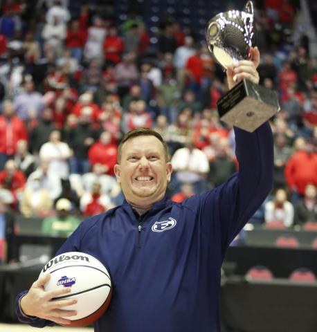Lady Devils Head Coach Josh Jones holds up the GHSA State Championship trophy to the Elbert County crowd after defeating Rabun County 52-44 to bring home the program’s first-ever state title. Jones has been the Lady Devils’ head coach for the last four years after being named to the position in 2018. Before being head coach, Jones served as an assistant at the high school under Alton Smith and Wes Greer. (Photo by Scoggins) 