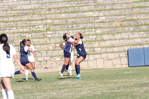 Left, Lady Devils Victoria Medellin and Hannah Halavin celebrate a goal during the team’s win over Elite Scholars Academy in the first round of the GHSA playoffs. (Photo by Wells) 