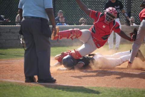 Therell’s catcher falls on Diamond Devil Trustin Allen after he slid safely into home plate during the first round of the GHSA state playoffs at Diamond Devil field Friday, April 29. (Photo by Scoggins) 