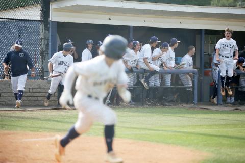 Senior Cole Hudson doubled during the first game against the Jeff Davis Yellow Jackets Wednesday, May 4 to score the first run of the game by fellow senior Carson Adams. Senior Caden Brown (right) and the Diamond Devils react to Hudson’s hit as he runs towards first base. 