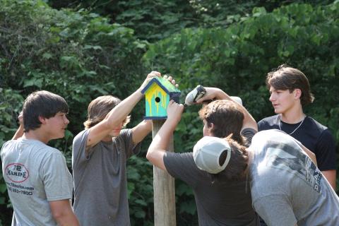 Members of the Key Club at Elbert County Comprehensive High School install birdhouses at Sutton Park Friday, May 20. (Photo by Wells) 
