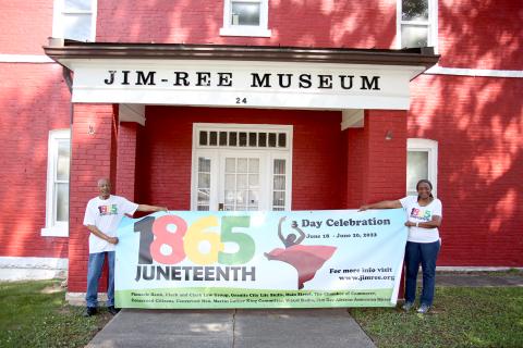 Jimmy White (left) and Aurolyn Hamm White (left) showcase the banner that will be hung from the entrance of the Jim-Ree Museum showcasing the three day Juneteenth Celebration planned for Saturday, June 18 through Monday, June 20. (Photo by Scoggins)
