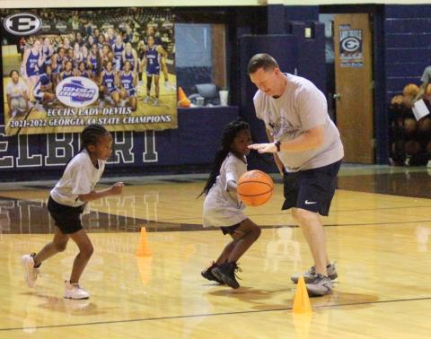 Lady Devils Head Coach Josh Jones practices skills with Lady Devil Youth Campers (L-R) Skylar Henderson and Kassydi Mattox during the state champions’ camp at the end of June in the Inferno. (Photos by Wells) 