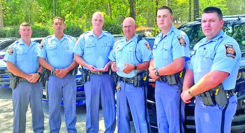 Georgia State Patrol troopers — Cory Andrews, Brad Cuevas, Dustin Welborn, Kiefer Smith, Bryan Randall, Jesse Lamb and Matthew Bradley — from Post 52 show the trophies they received from MADD Georgia for their efforts combating drunk driving in 2021.