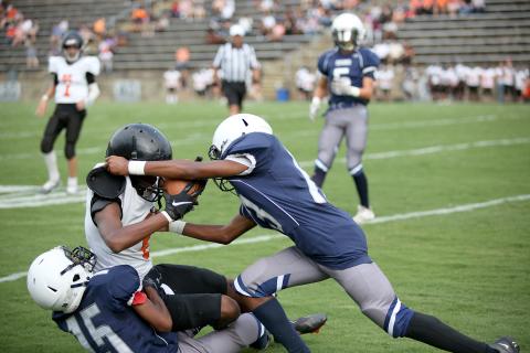 La’Dricus Jackson (No. 15) and Mekhai Washington (No. 13) tackle a Hart County player during the Aug. 20 game in the Granite Bowl. The Rams will travel to Stephens County Sept. 1 for their second game of the season. (Photo by Wells) 
