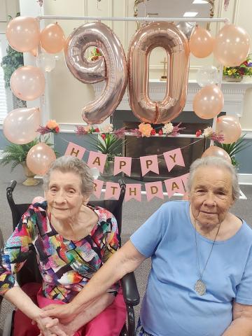 Juanita Wilder Adams Scruton (right) smiles for a picture with her oldest sister, Betty Wilder Looney (left) during her surprise 90th Birthday party. Looney will celebrate her 94th birthday Aug. 19.