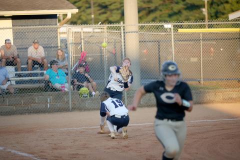 Senior Lilly Ray throws a ball to first base in an attempt to tag a Commerce runner out during the Lady Devils’ region win Sept. 20. (Photo by Wells) 