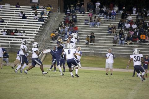 Sophomore Jermaine Sims (No. 3), senior DeCorius “Bubba” Heard (No. 31) and senior Keithshun Tate (No. 9) watch as senior Christian Harris (No. 11) intercepts a Warrior ball during Friday’s 21-3 win over Jefferson County High School. (Photo by Scoggins) 