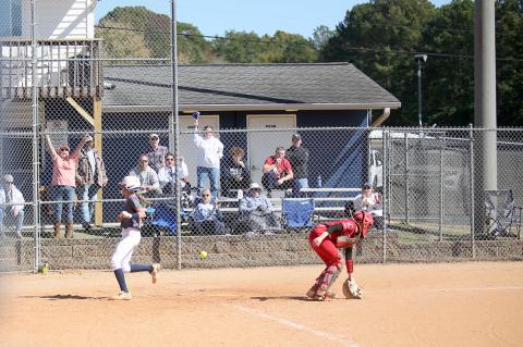 The crowd cheers as freshman Kamryn Webb safely crosses home plate during the Lady Devils’ season-ending 7-4 loss to Social Circle in the super regionals of the GHSA state playoffs Oct. 19. (Photo by Wells) 