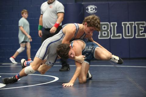 Eighth grader Rilee Rucker (gray) wrestles fellow eighth grade teammate Jackson Black (blue) during the Ram Invitational Saturday, Nov. 5 in the Inferno. The Rams kicked off their season with the home-opening invitational and placed first as a team. (Photo by Scoggins)