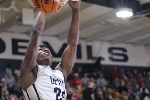 Senior Quan Moss makes a dunk during the Devils’ loss to Madison County Friday, Dec. 9 in the Inferno. (Photo by Wells)