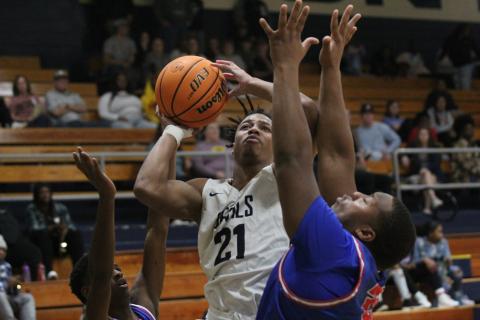 Senior Trustin Allen takes a shot between two Oglethorpe County defenders during the Devils’ 59-46 loss in the Inferno Dec. 17. (Photo by Wells) 