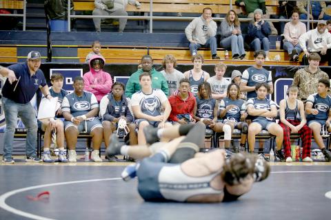 Mat Devils Head Coach Shane Anderson (far left) coaches Carter Fleming during a match against Commerce High School in the area duals Jan. 7 in the Inferno. Anderson hit his 200th dual win as a coach in December. (File photo by Scoggins)
