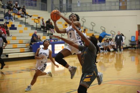 Aaniyah Allen soars to the basket during the Lady Devils’ 61-43 loss against AAAAA fifth-ranked Jones County during the Cedar Shoals Winter Classic Dec. 30. (Photo by Scoggins) 