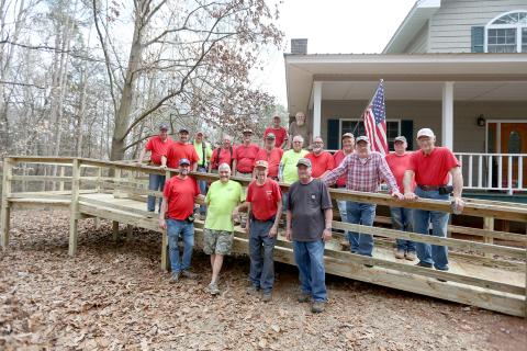 First Baptist Church Ramp Ministry members pictured are (first row, L-R) Jarrod Gunn, Keith Madden, Sam Pagett and Blaine Worley; (second row, L-R) Kyle Branan, Tim Adams, Larry Gillham, Bill Palmer, James Adams, Steve Hall, Bobby Jones, William Loggins, Kyle Brown, Charlie Roberts, Steve Rousey and Harley Thomas; (third row, L-R) Richey Eckler and ramp recipient Neil Summerour. (Photo by Scoggins)