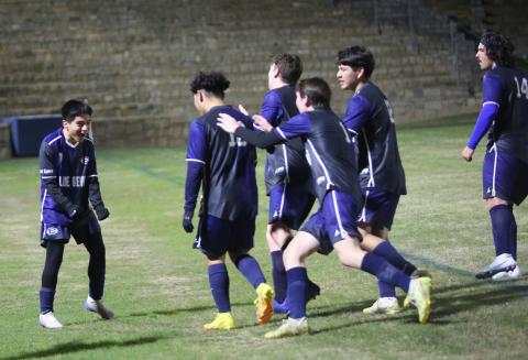 A group of Blue Devils celebrate with teammate Pablo Medellin (left) following the team’s 4-3 overtime win over Rabun County March 14 in the Granite Bowl. The win put the Devils in second place in the region. (Photo by Wells)