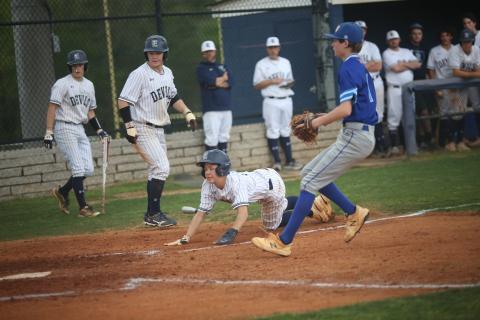 Diamond Devils (L-R) Eli Harris and Skyler Bray watch as Brayden Ingram slides safely into home plate during a doubleheader against region opponent Barrow April 6. (Photo by Wells)