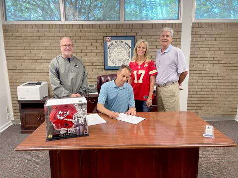 Pictured during a proclamation signing for Mecole Hardman Jr. week leading up to the Friends Helping Friends (FHF) annual pageant and live action are (L-R) Superintendent Jon Jarvis, Mayor Daniel Graves, FHF Founding President Sandy Adams and Jeff Adams. 