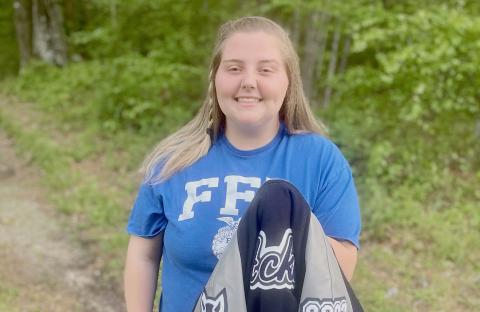 ECCHS senior Natalie Acker (left) holds the first letterman jacket obtained by being an FFA Club member. 