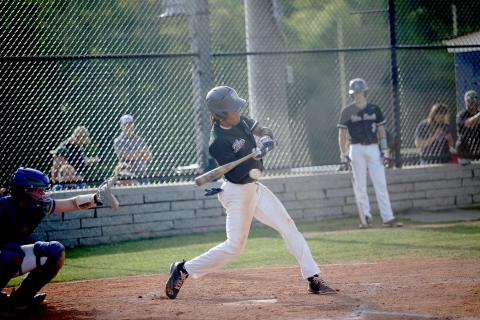 Senior Trustin Allen puts the ball in play during the Diamond Devils’ 14-3 win over Washington Wilkes April 19. (Photo by Wells)