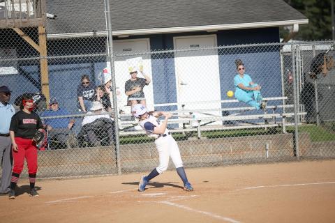 Senior Ava Lunsford drills a ball into the outfield during the Lady Devils game against Gainesville March 29. (Photo by Wells)