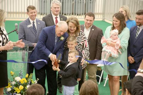 Pictured during a ribbon cutting for the new Tom McCall Agriscience Complex March 31 are (front row, L-R) Tom McCall, cutting the ribbon with help from grandsons Winn and Wilkes McCall, and Jane McCall and (back row, L-R) Technical College System of Georgia Commissioner Greg Dozier, U.S. House District 10 Rep. Mike Collins, Georgia Agriculture Commissioner Tyler Harper, Katie McCall Archer and McCall Kate Archer and Rachel McCall. (Photo by Scoggins) 