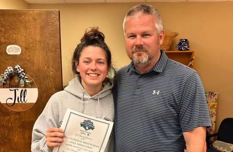 Senior golfer Abby Byrant (right), pictured with Head Golf Coach Larry Kesler, has been selected to by the National High School Golf Association to compete in the Girls National High School Golf Invitational for the second year in a row. The event will take place July 10-12 at the Omni Professional Golf Association Frisco Resort in Frisco, Texas.