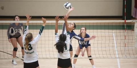 America Vargas spikes the ball as two Athens Academy players try to block her shot in Elbert’s 2-0 loss to the Spartans Aug. 24. (Photo by Wells)