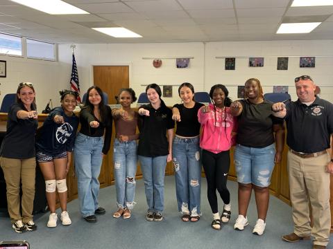 Pictured with their rings are (L-R) Nicole “Drill Mama” Ulrich, Team Leader De’Asia Kinsey, Natasha DeLeon, Chrisiya Harris, Jaelyn Massey, Jolette Medina-Galvan, Ke’miyah Teasley, Co-Captain Nakira Baker and Sgt. 1st Class Daniel Ulrich. Not pictured are Team Captain Lucas Vang and Kaleigha Montgomery. (Photo by Wells)