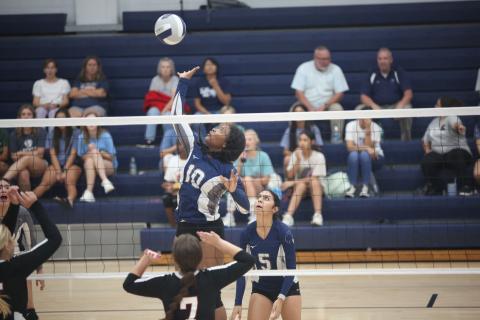 America Vargas (No. 5) watches as Keitasia Glaze (No. 10) leaps to spike a ball in Elbert County’s 2-0 loss to Rabun Aug. 17. The Volley Devils are 3-7 so far on the season with wins over Monsignor Donovan, Washington-Wilkes and Cedar Shoals. (Photo by Wells)