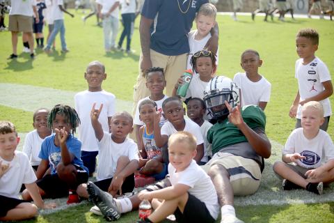 Blue Devil pride was on display Aug. 11 as the football team participated in two community events to get them ready to kick off the season. Above, Elbert County Parks and Recreation players pose for a photo with quarterback Jayvyn Hickman at the Granite Bowl kickoff event hosted by the True Blue Booster Club. 