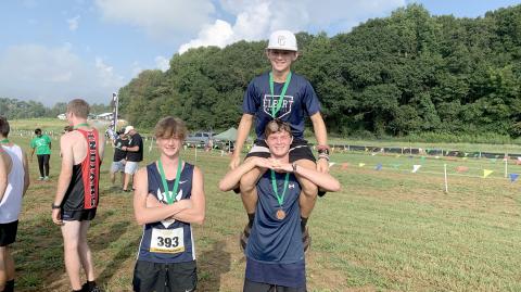 Ezra Adamson, (top) Dakota Toole and (bottom) Connor Holland pose with their Top 10 medals after the meet in Franklin County Sept. 9. (Photo by Wells) 