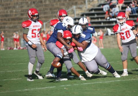 A pair of Rams tackle a Stephens County player as the ball pops loose for a fumble in Elbert’s 22-0 loss to the Rebels Aug. 31. (Photo by Wells)