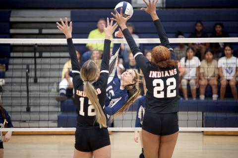Elbert County Volley Devil Johna Johnson hits the ball over the net as two Stephens County players try to block her shot. (Photo by Wells)
